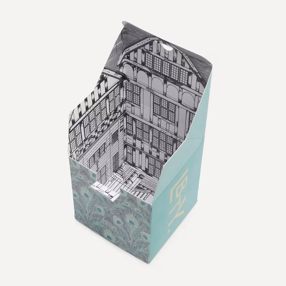 Cardboard box with architectural design on the interior in front of a white background