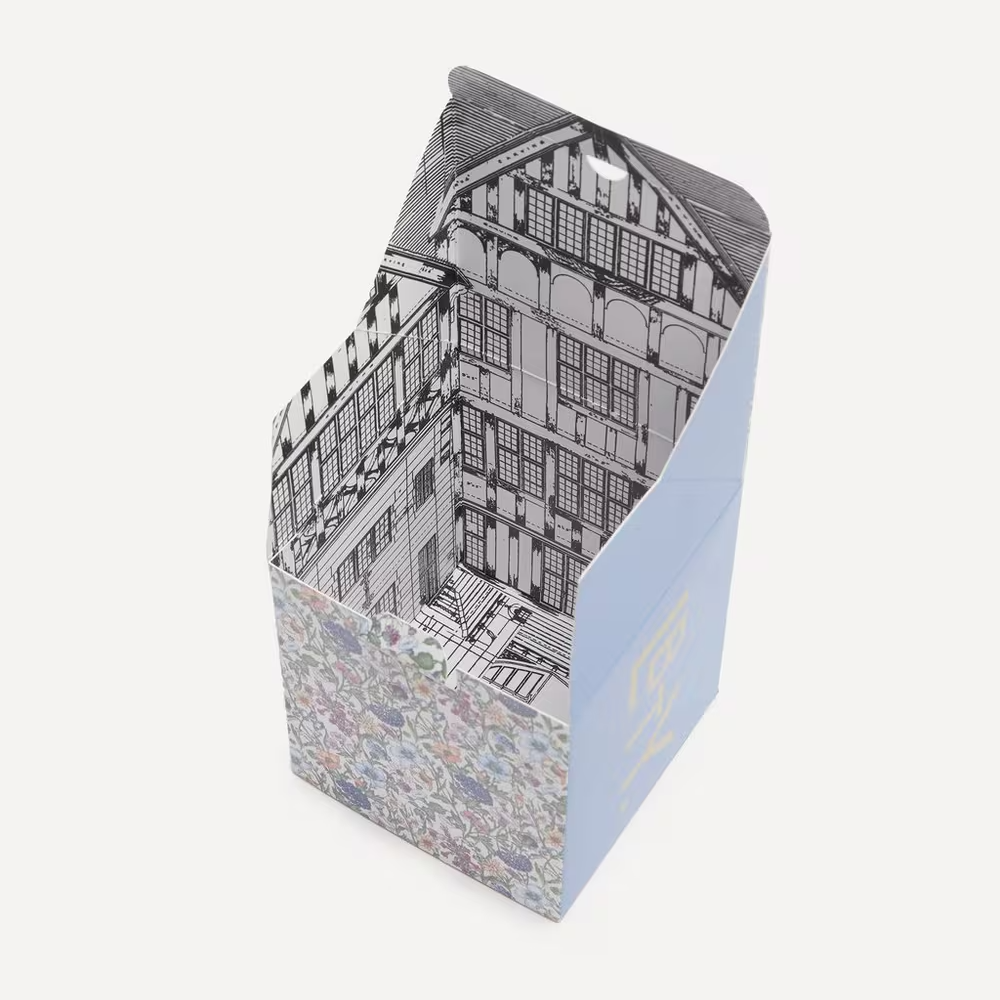 Candle box with architectural design on the interior in front of a white background