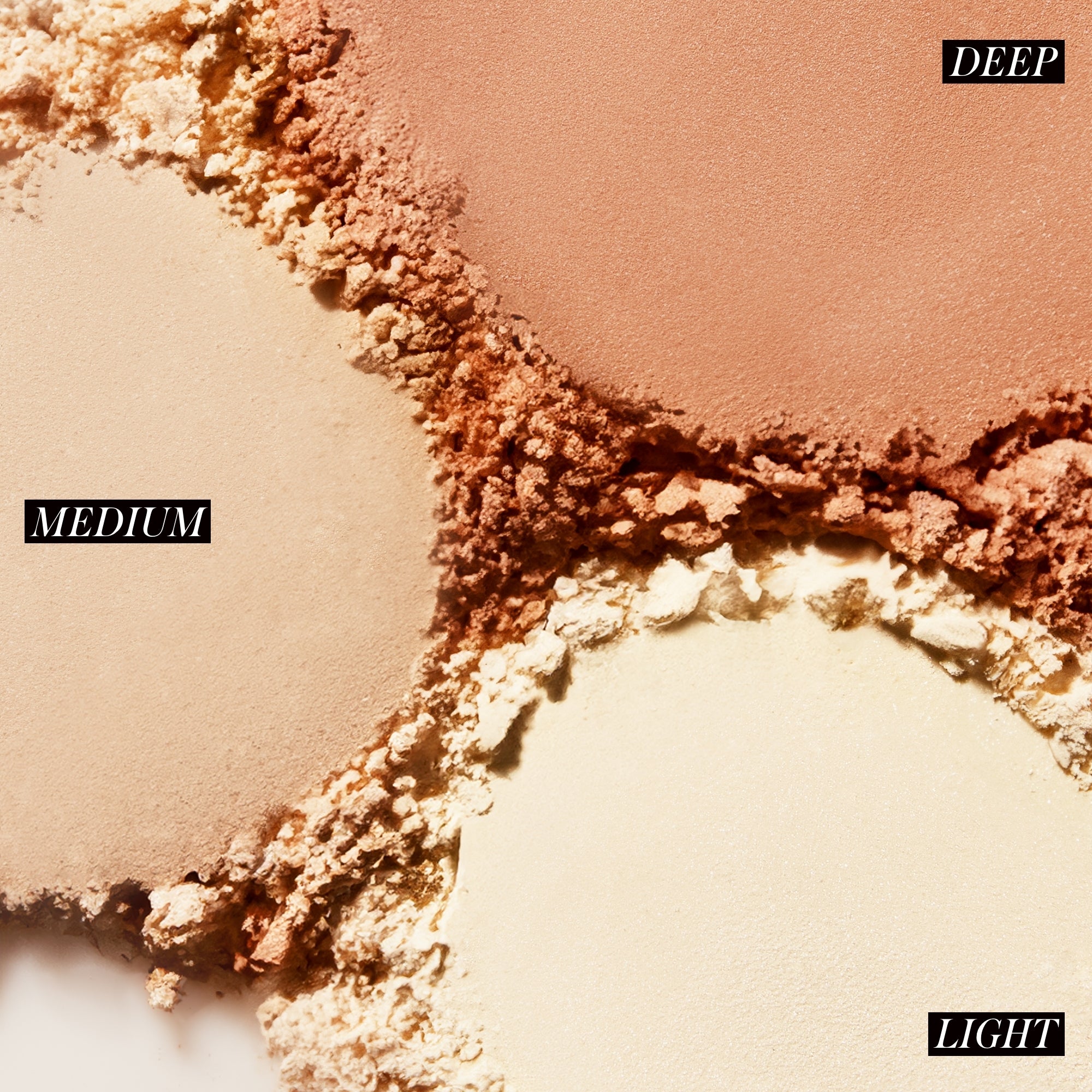 Close-up of different shades of makeup powder labeled 'Deep', 'Medium', and 'Light'.