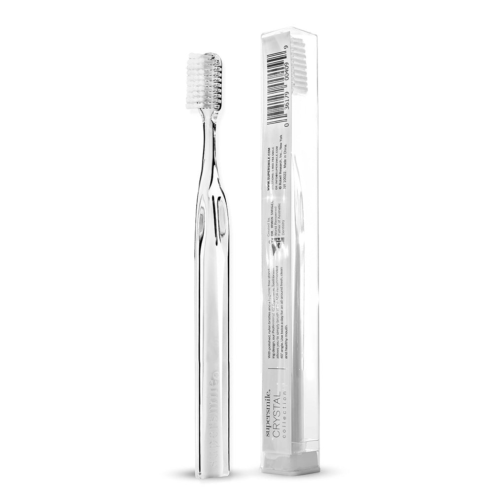 Clear Supersmile  toothbrush with packaging on a white background