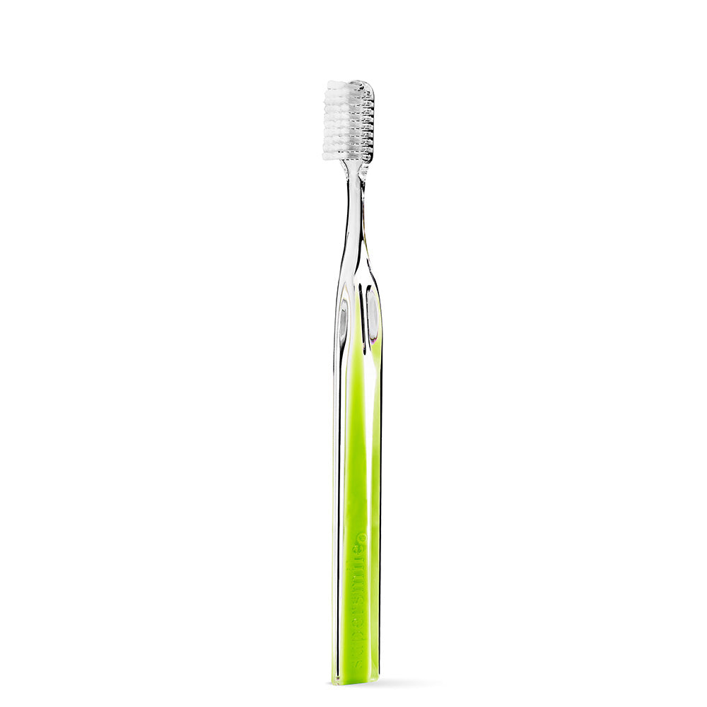 Supersmile Green toothbrush with packaging on a white background