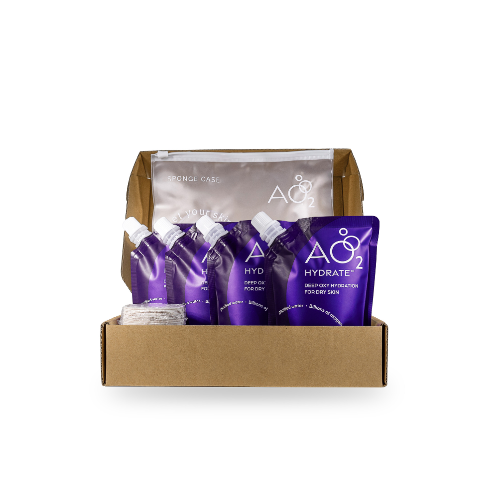 Box containing purple skincare products with a brand logo on a white background