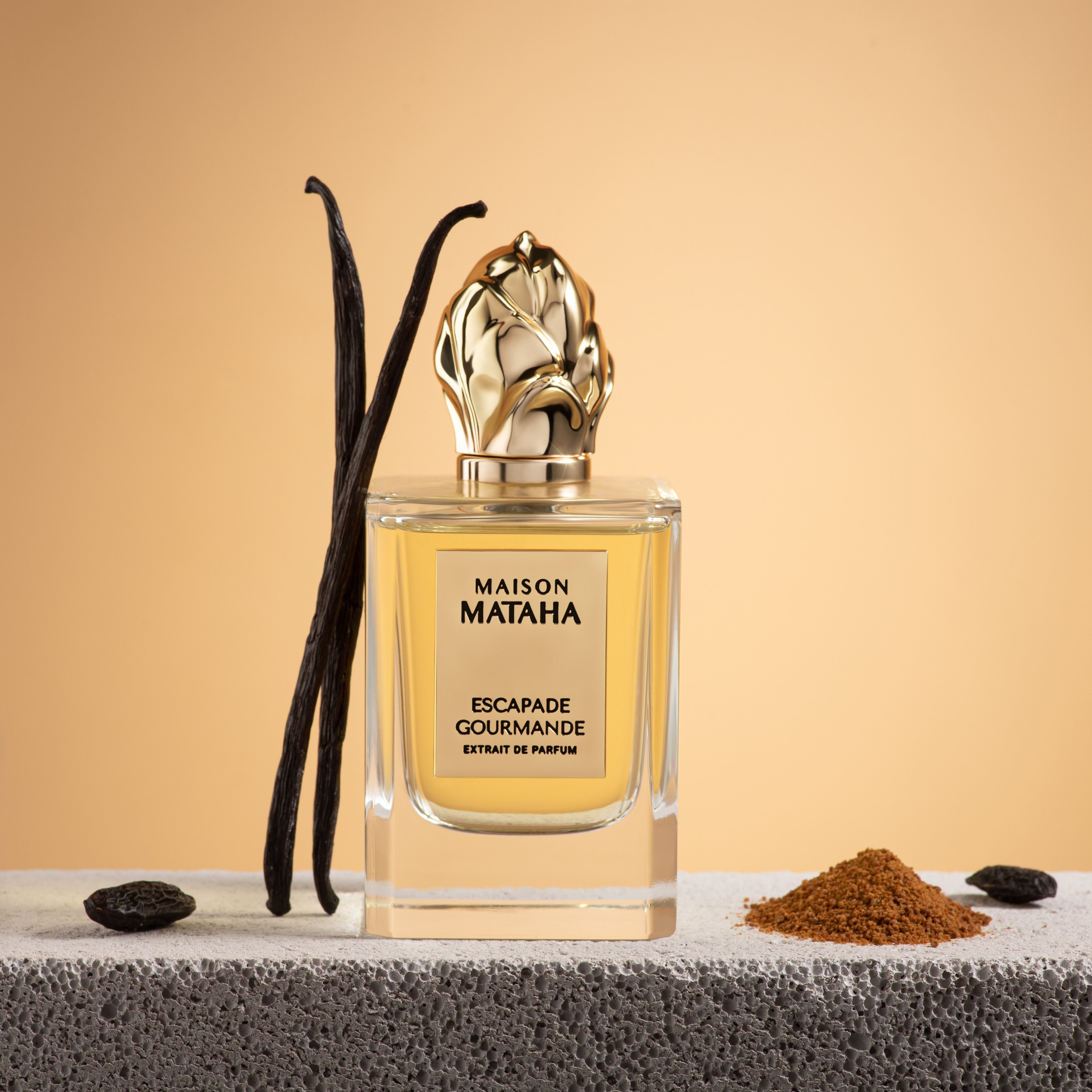 Maison Mataha perfume bottle next to vanilla and spices