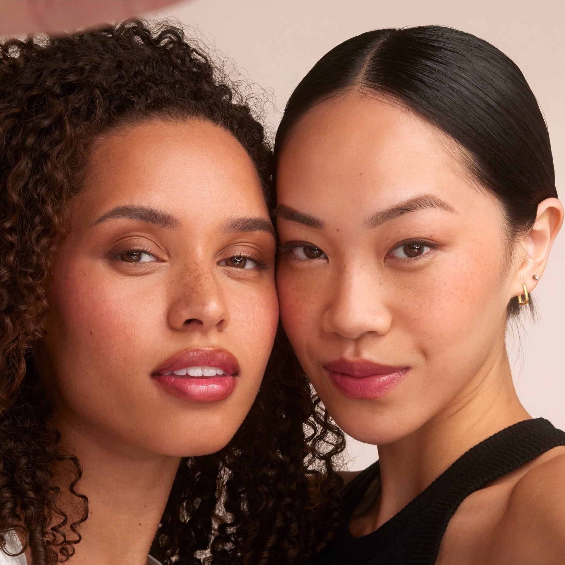 Two women wearing RMS Hydra Setting Powder posing against a neutral background