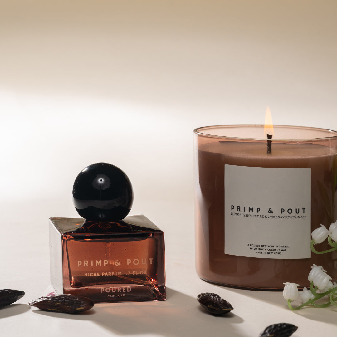 Candle and perfume bottle with 'Primp & Pout' branding on a neutral background