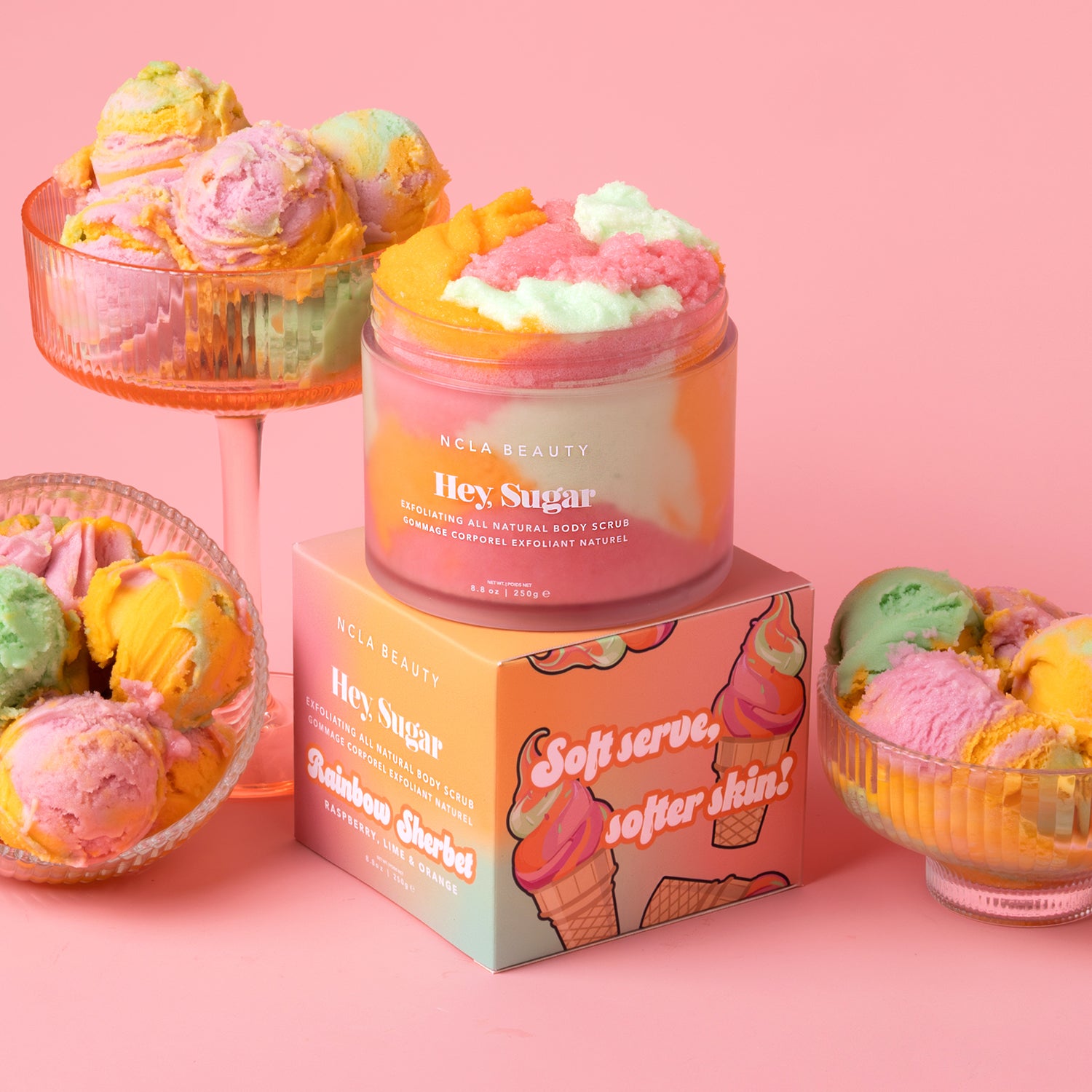 Jar of body scrub with ice cream-themed packaging on a pink background