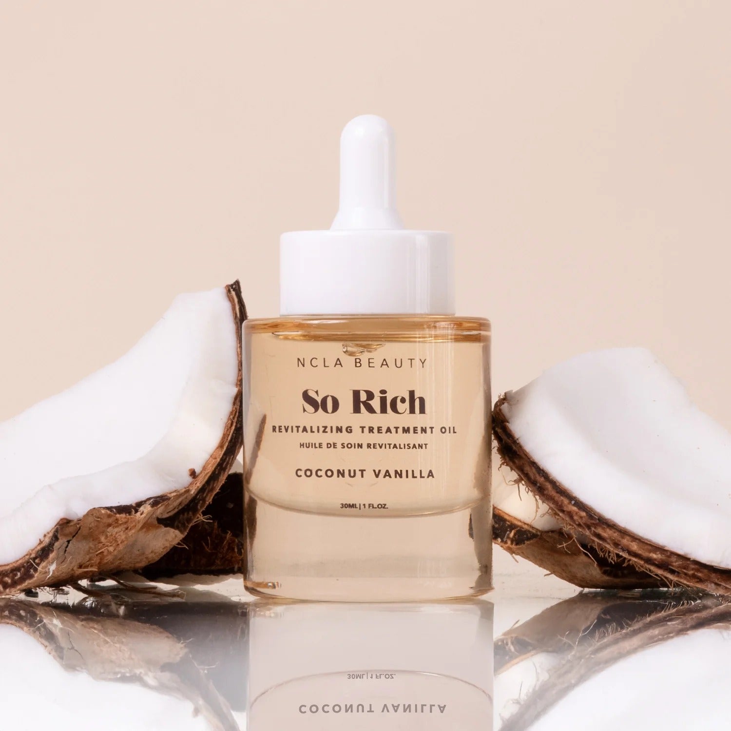NCLA Beauty So Rich revitalizing treatment oil with coconut halves on a beige background
