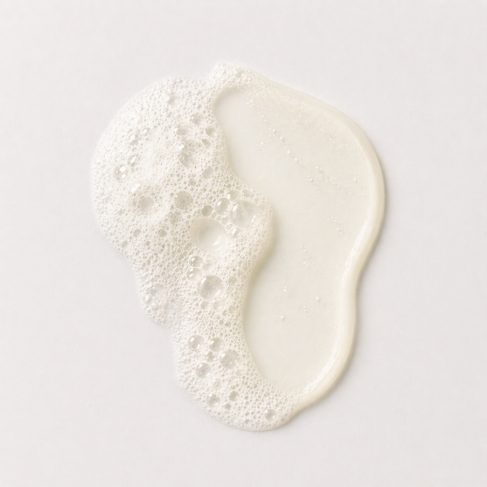 White cream colored product swatch with bubbles on a light gray background