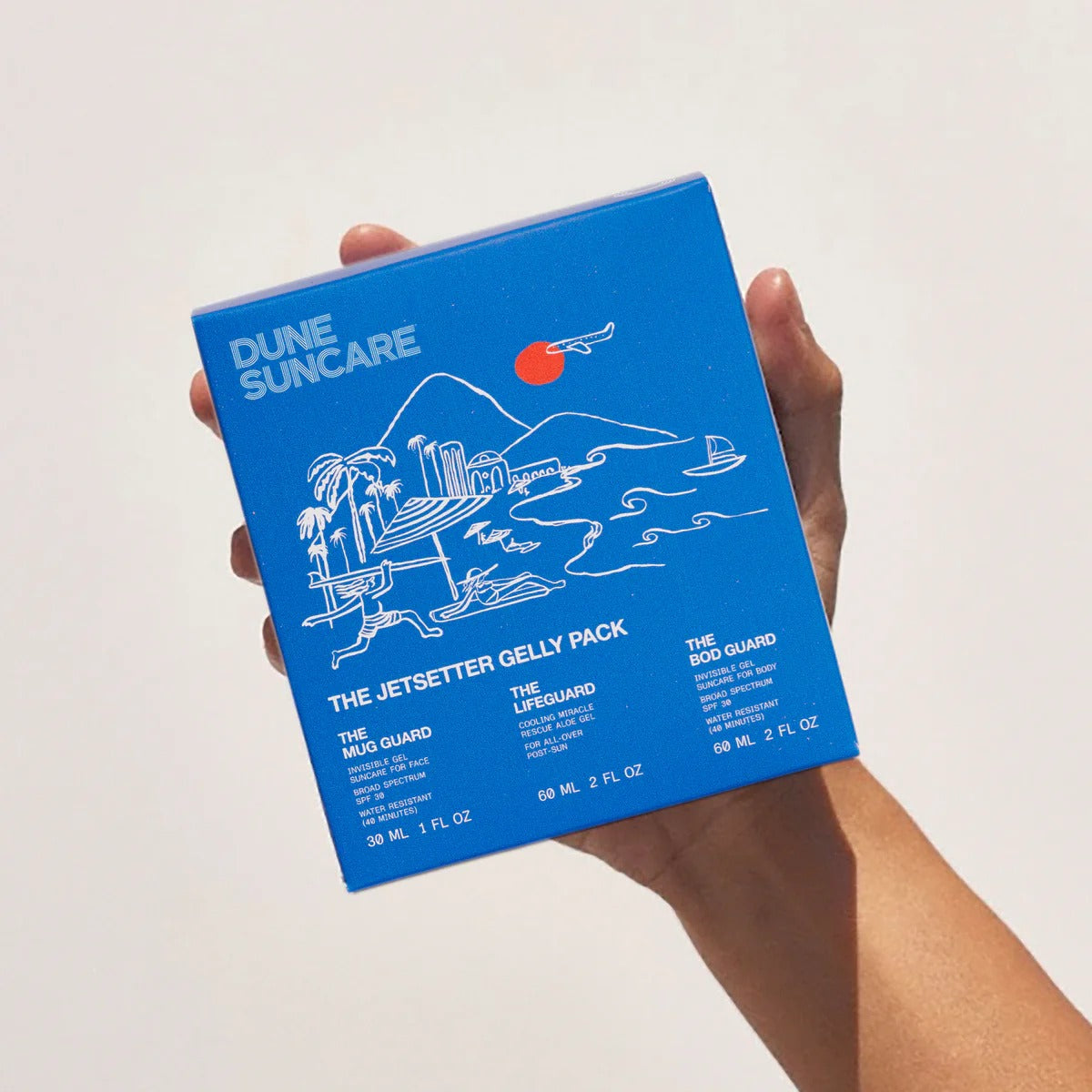 Blue packaging of Dune Suncare with illustrations on a white background