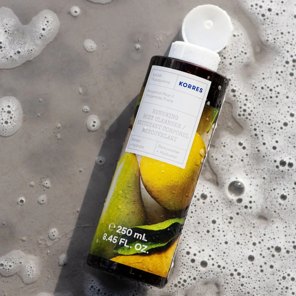 Korres bottle with pears on a soapy background