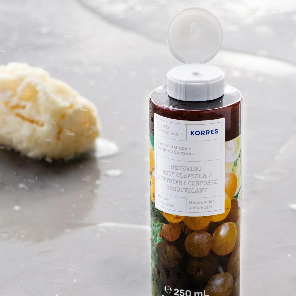 Korres bottle with olives on a white background
