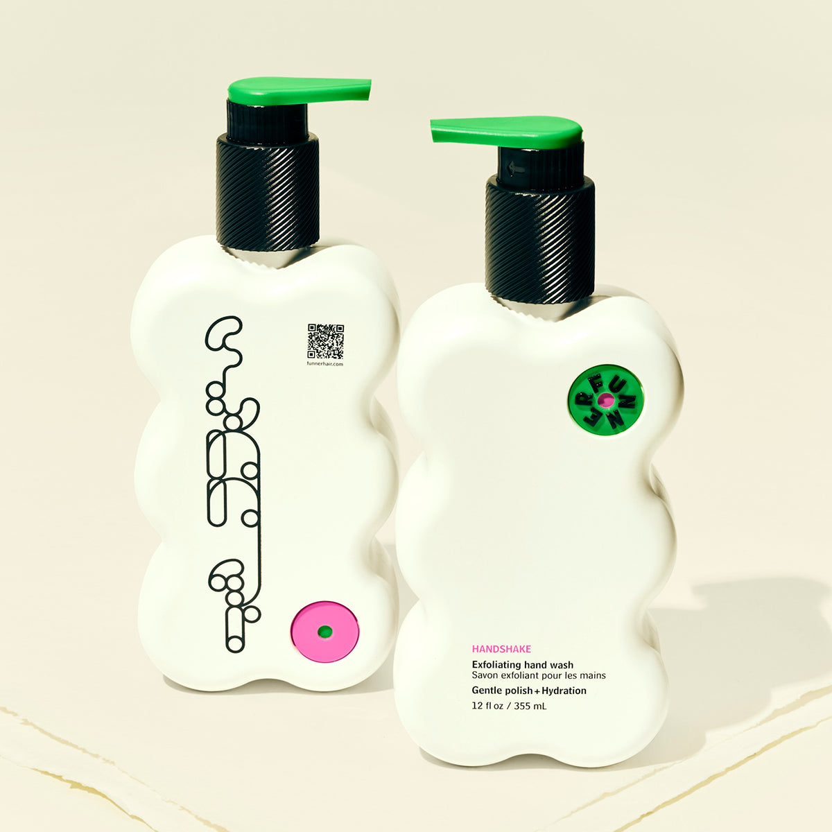 Two white bottles with green caps on a beige background