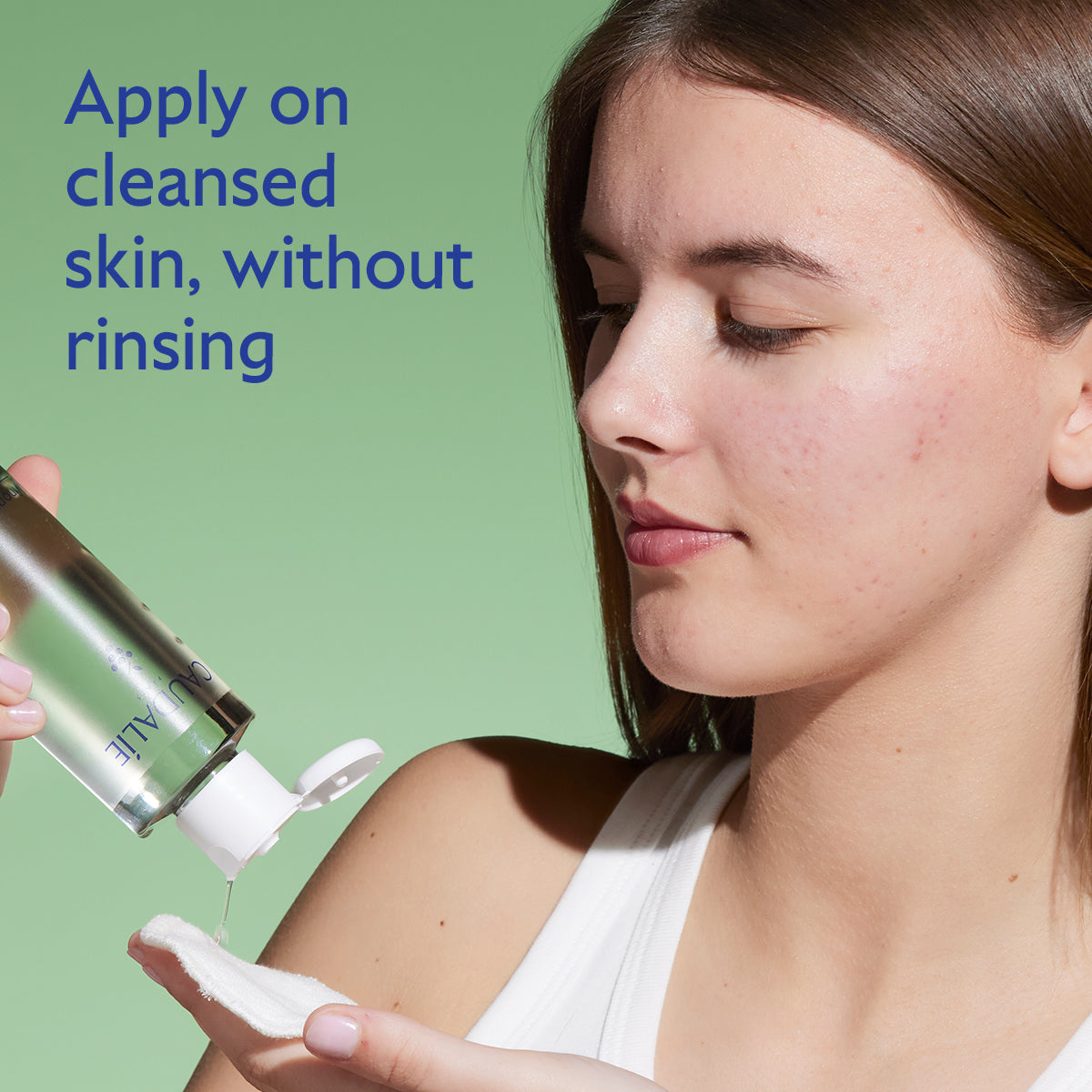 Woman applying skincare product with text on cleansed skin usage
