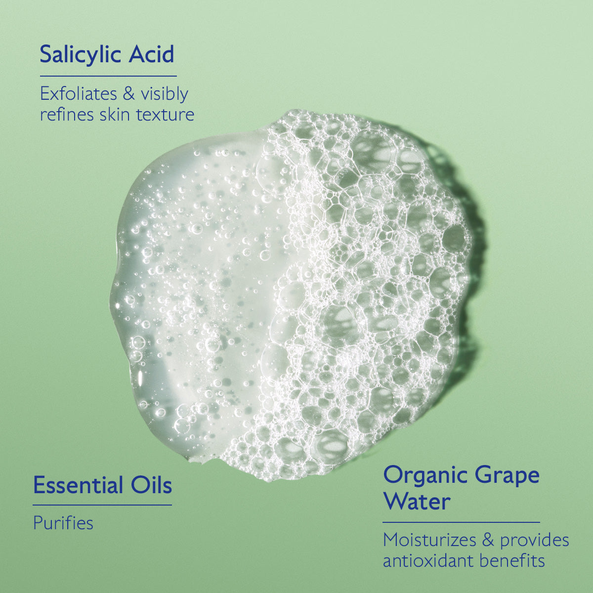 Product with bubbles on a green background, featuring text about salicylic acid, essential oils, and organic grape water.