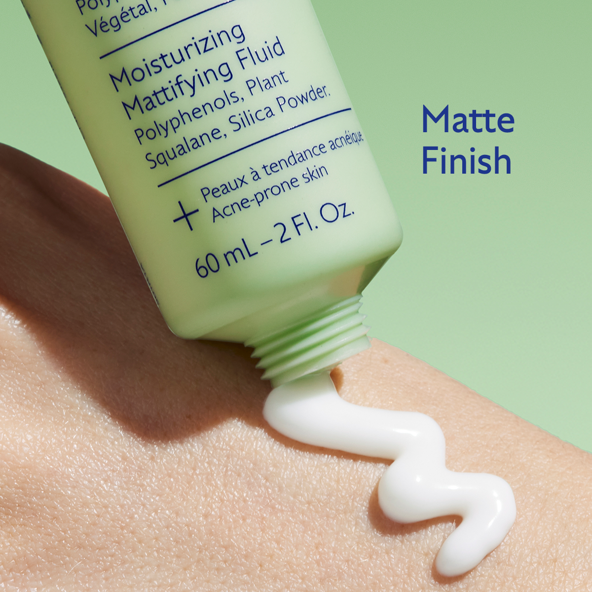 Moisturizing matting fluid being applied to skin with a green background