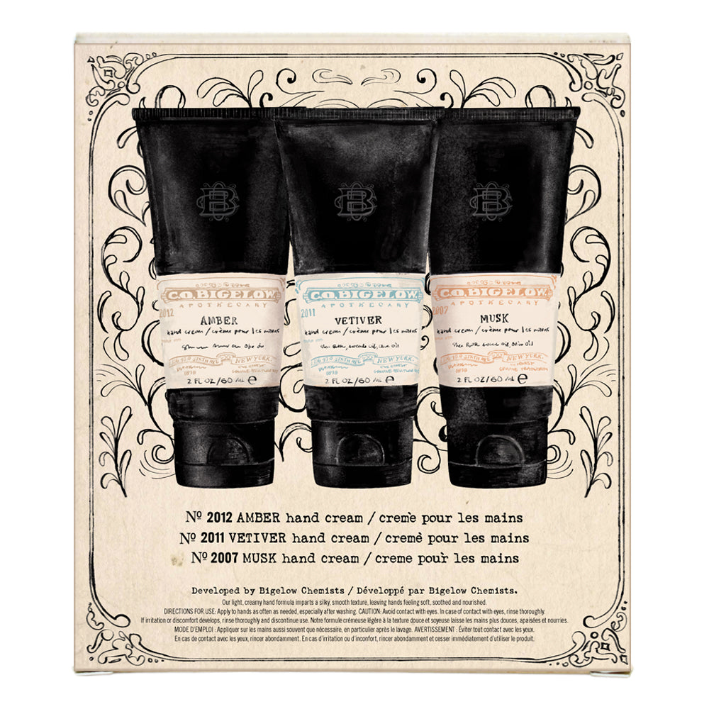 Set of three hand creams in black and white packaging on a decorative box.