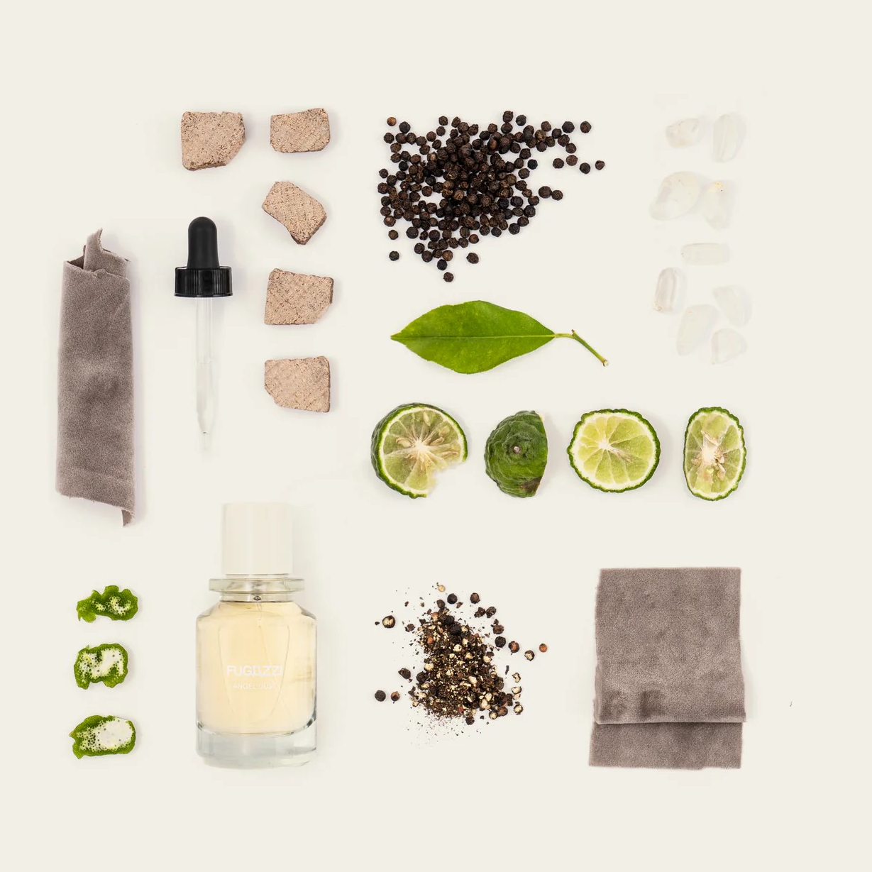 Fugazzi Angel dust perfume with spices, lime wedges around it.