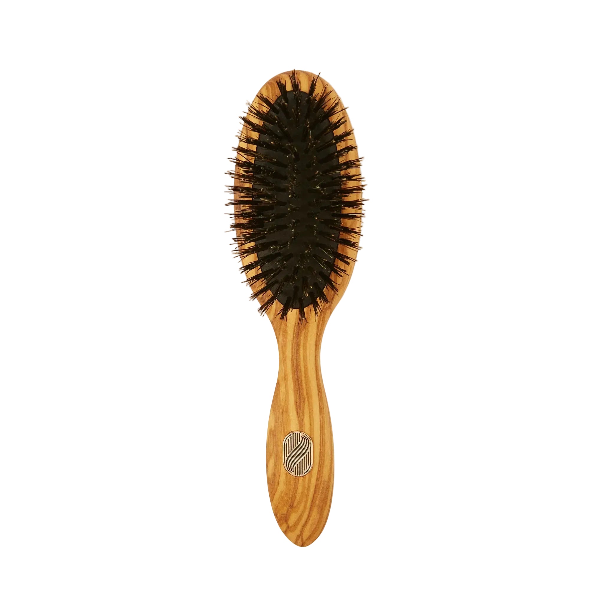An oval hairbrush with a light brown wooden handle and head, black bristles, and a small silver geometric logo on the handle, shown against a plain off-white background.