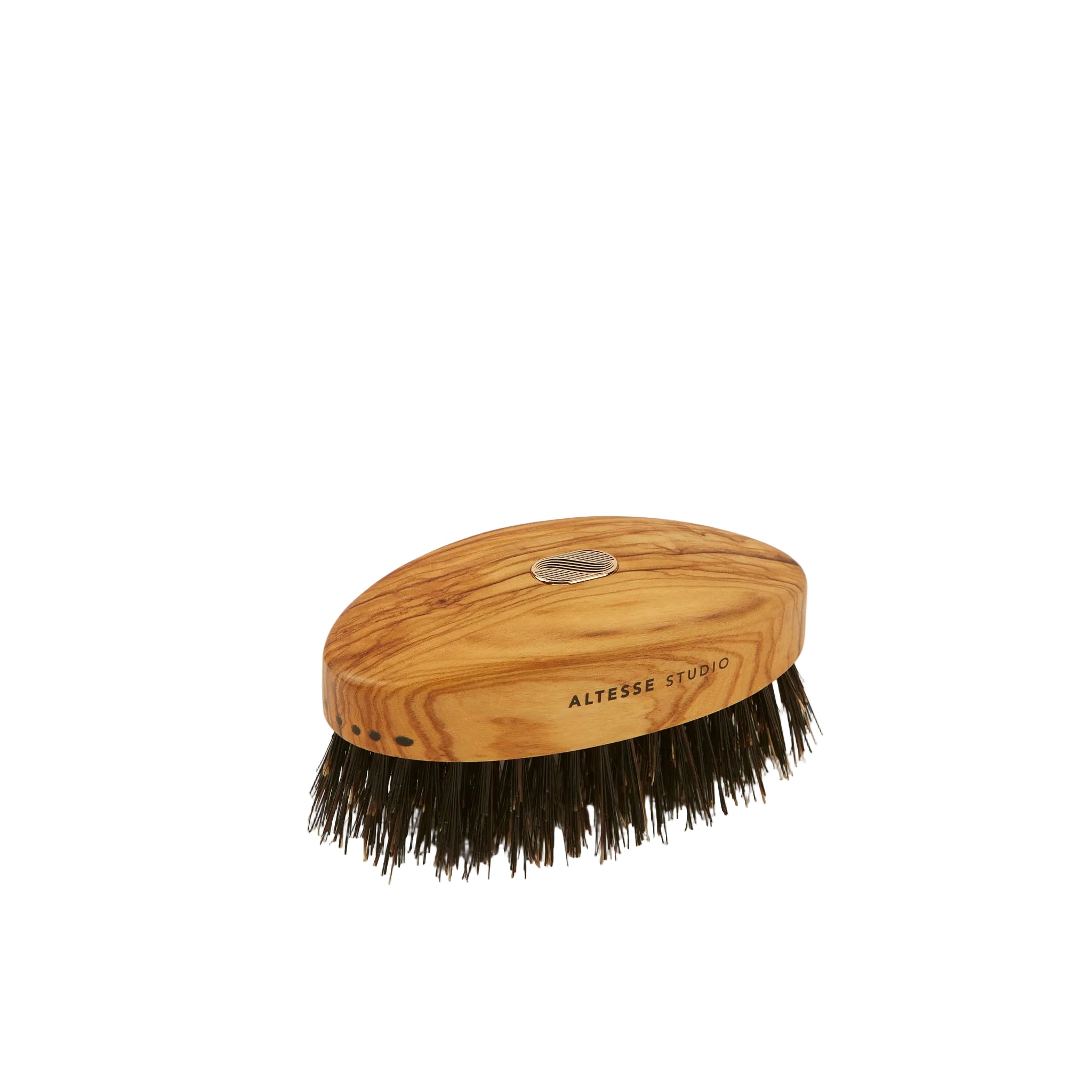 A small oval hair brush with a natural olive wood handle and dark bristles, photographed on a plain light beige background. The handle shows the brand name ALTESSE STUDIO.