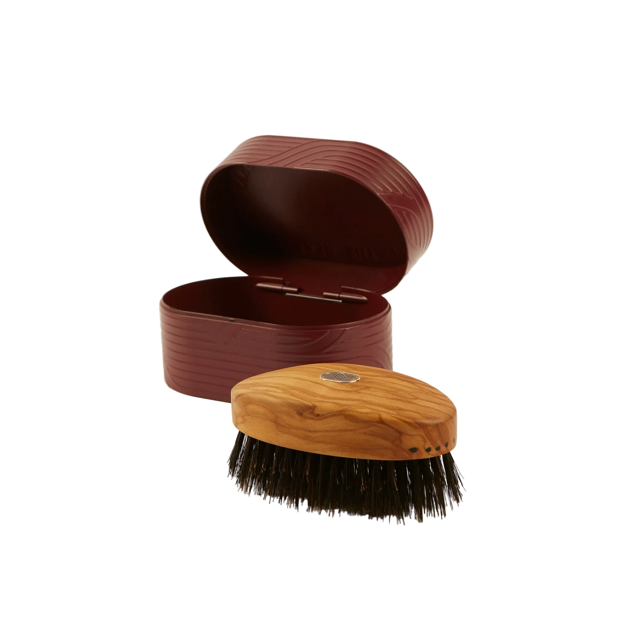Wooden brush with bristles and a matching brown case on a light beige background