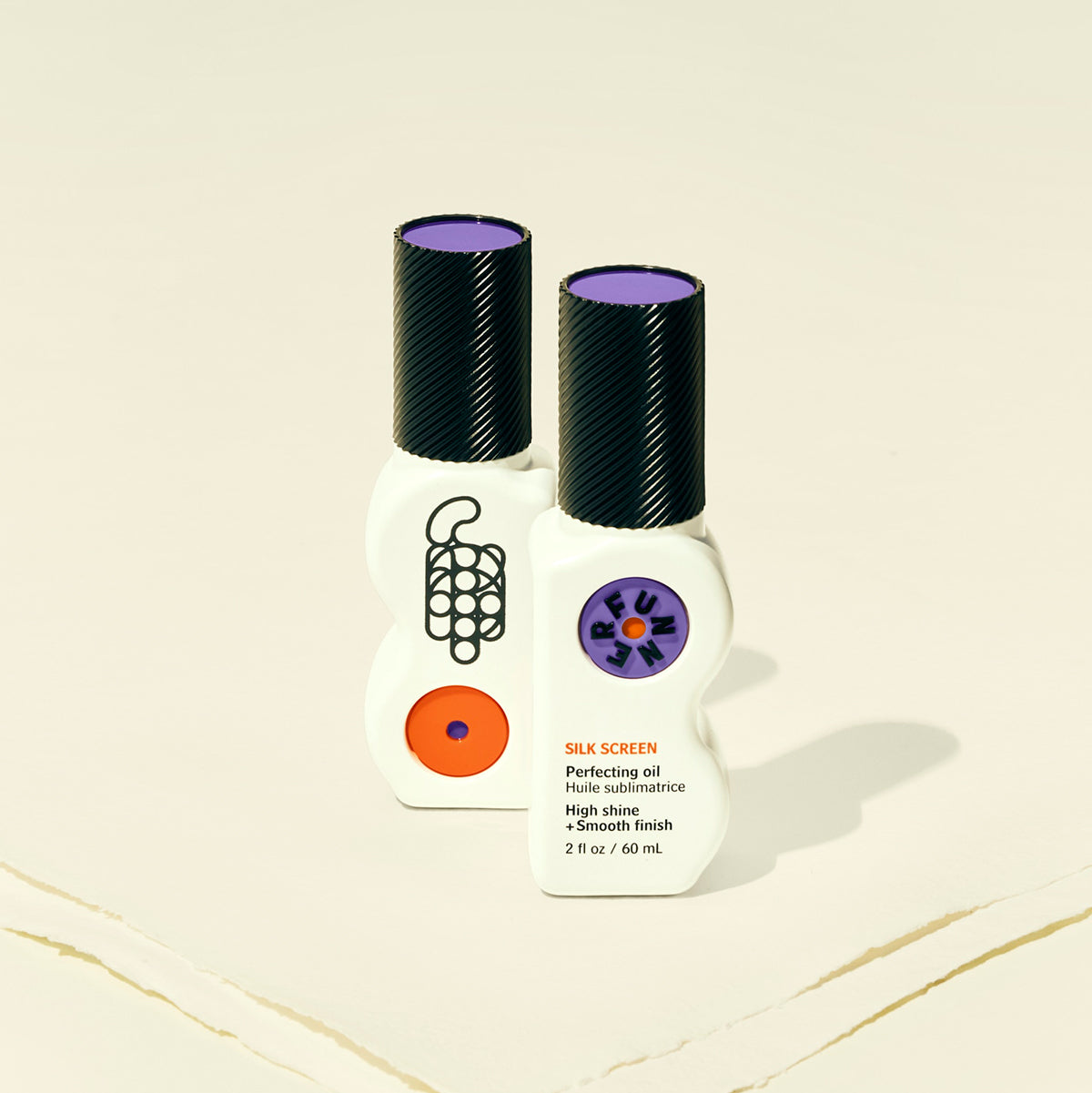 Two bottles of Silk Screen nail polish on a beige background