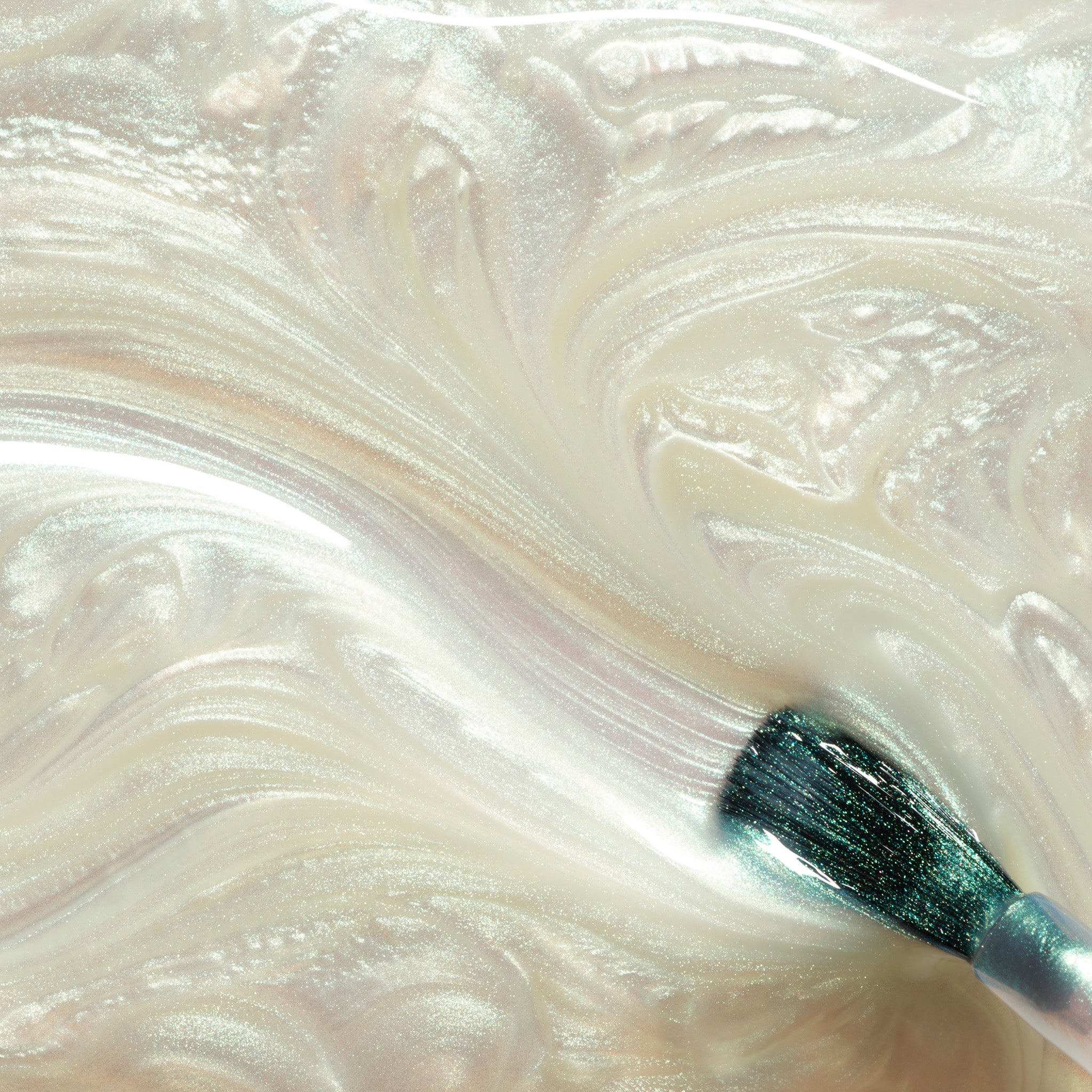 Close-up of Fairy glittery nail polish on a white and beige swatch.