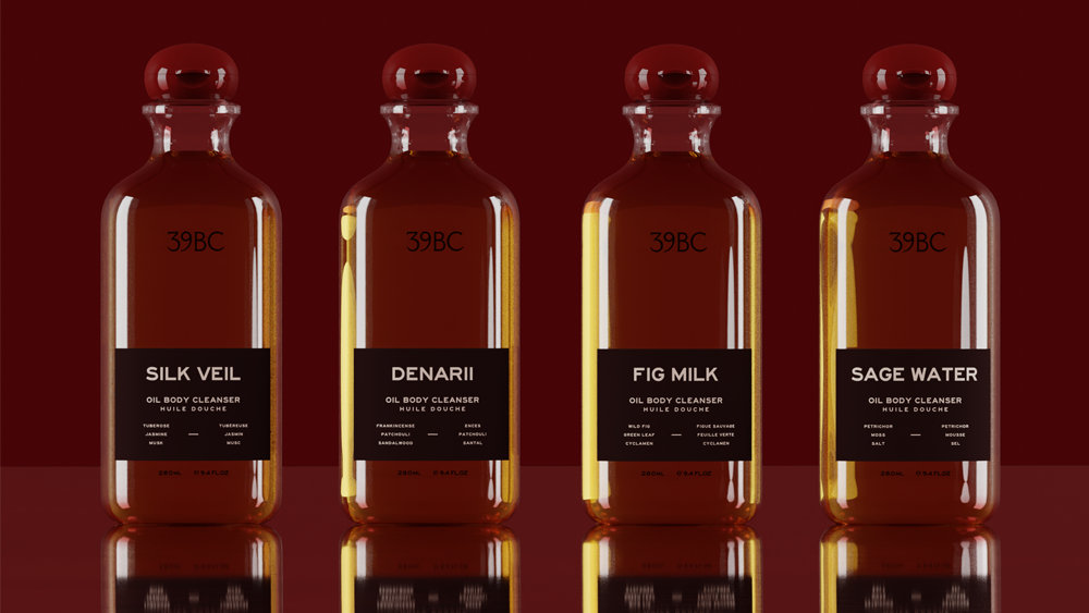 Four 39BC body cleanser bottles arranged in a row on a glossy dark red reflective surface. The bottles are made of clear glass and filled with amber-colored liquids, each with a black label and a red cap.