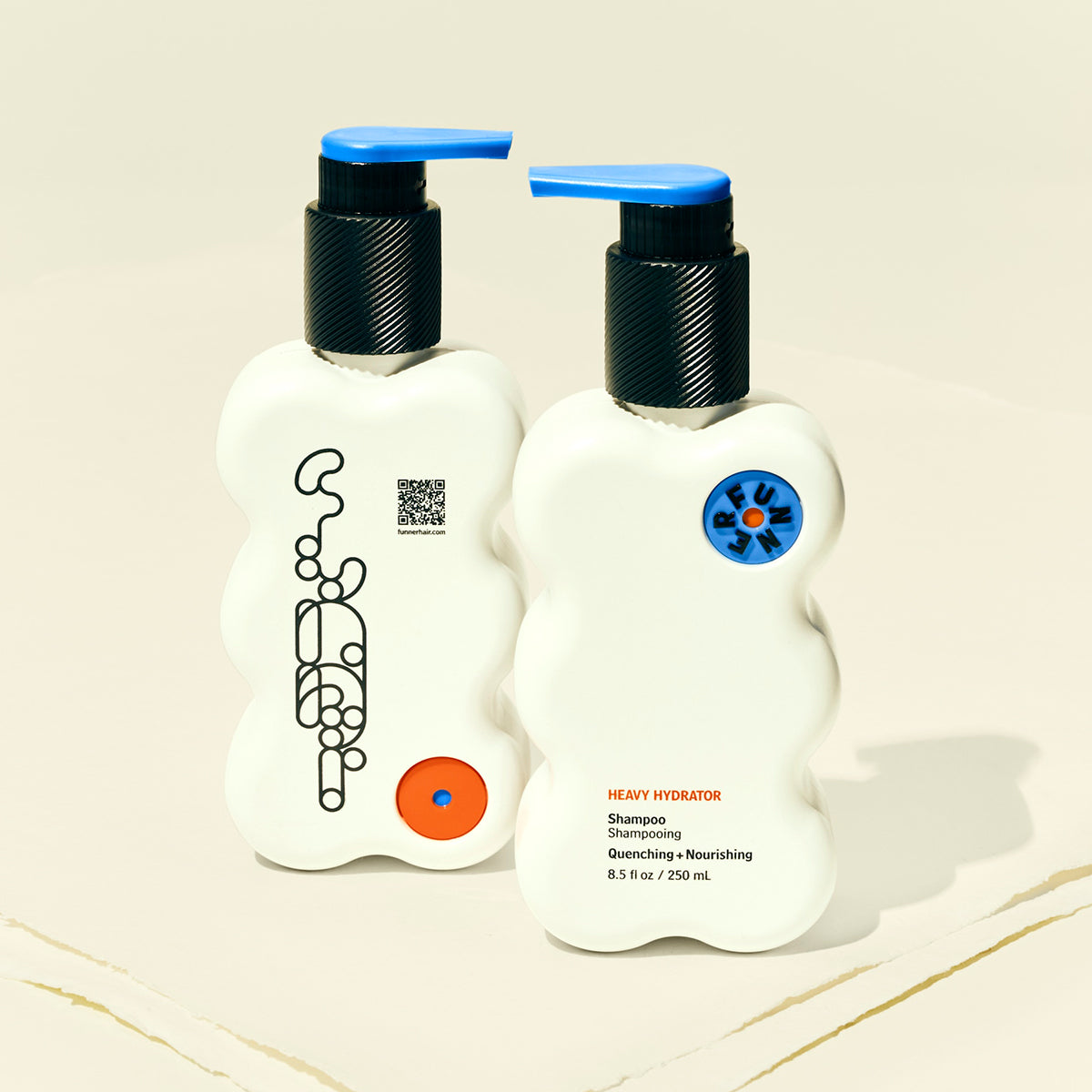 Two bottles of shampoo and conditioner with pump dispensers on a beige background