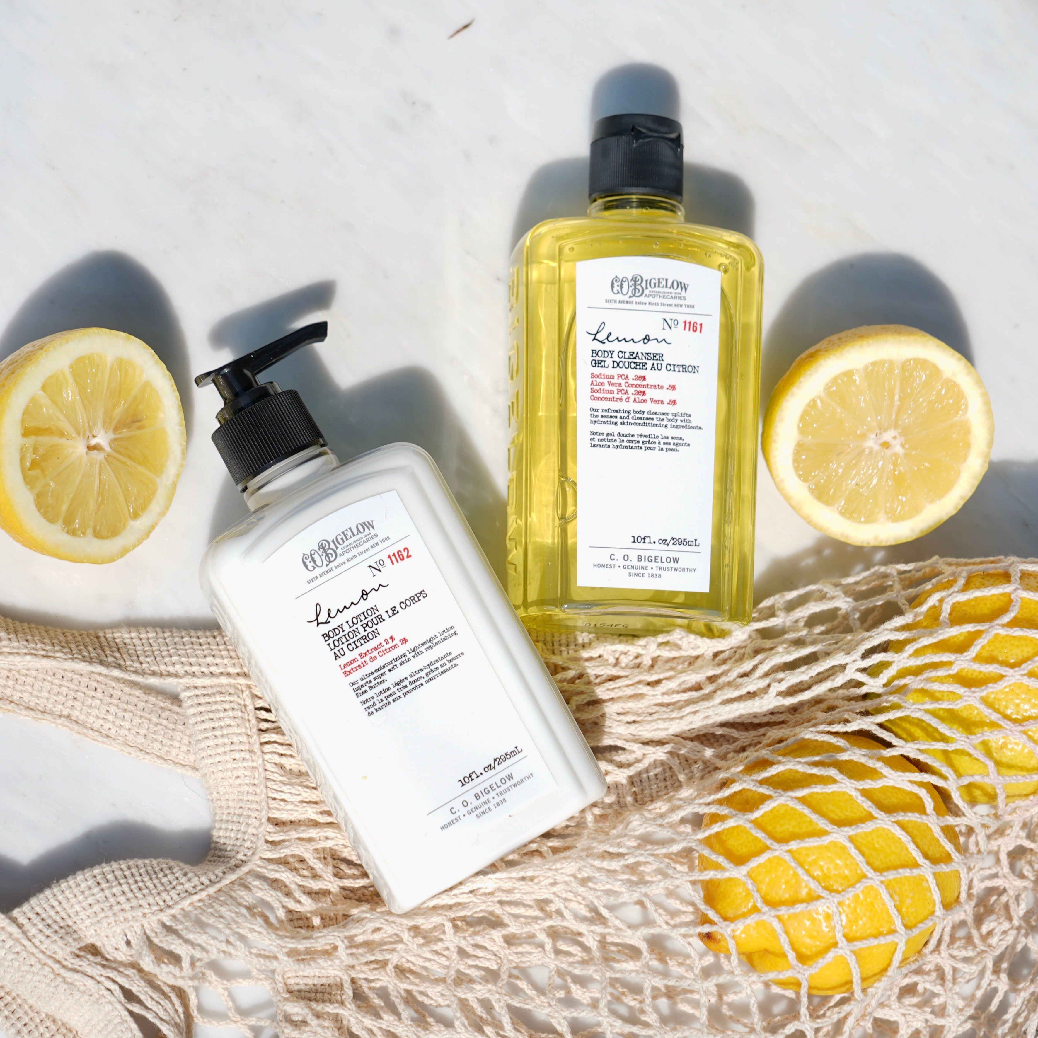 Lemon Body lotion and body cleanser CO Bigelow Body Care products with lemons on a textured surface