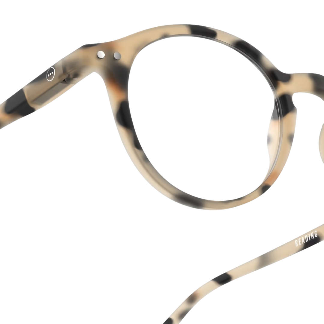 Close-up of light tortoiseshell eyeglasses on a white background