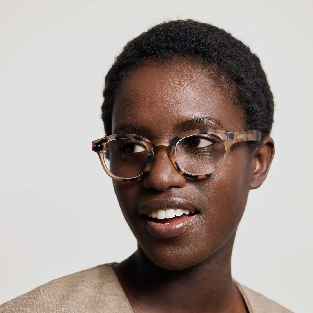 Woman wearing glasses with a neutral background