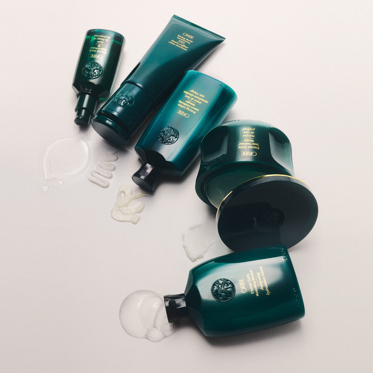 Set of green hair products on a light background