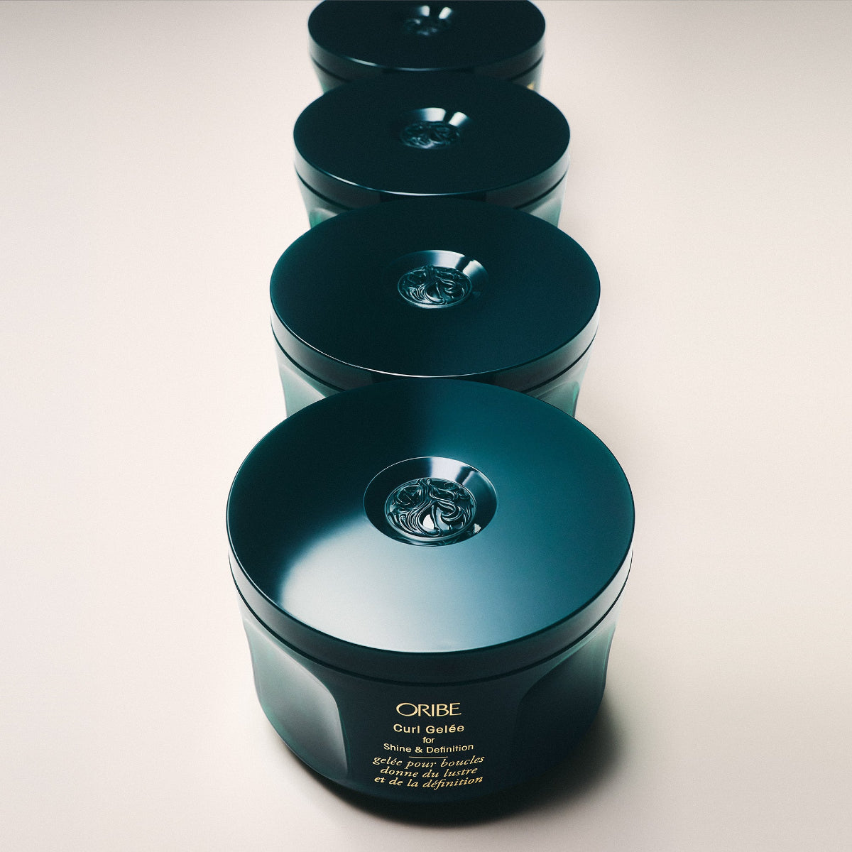 Line of Oribe hair product containers on a light background