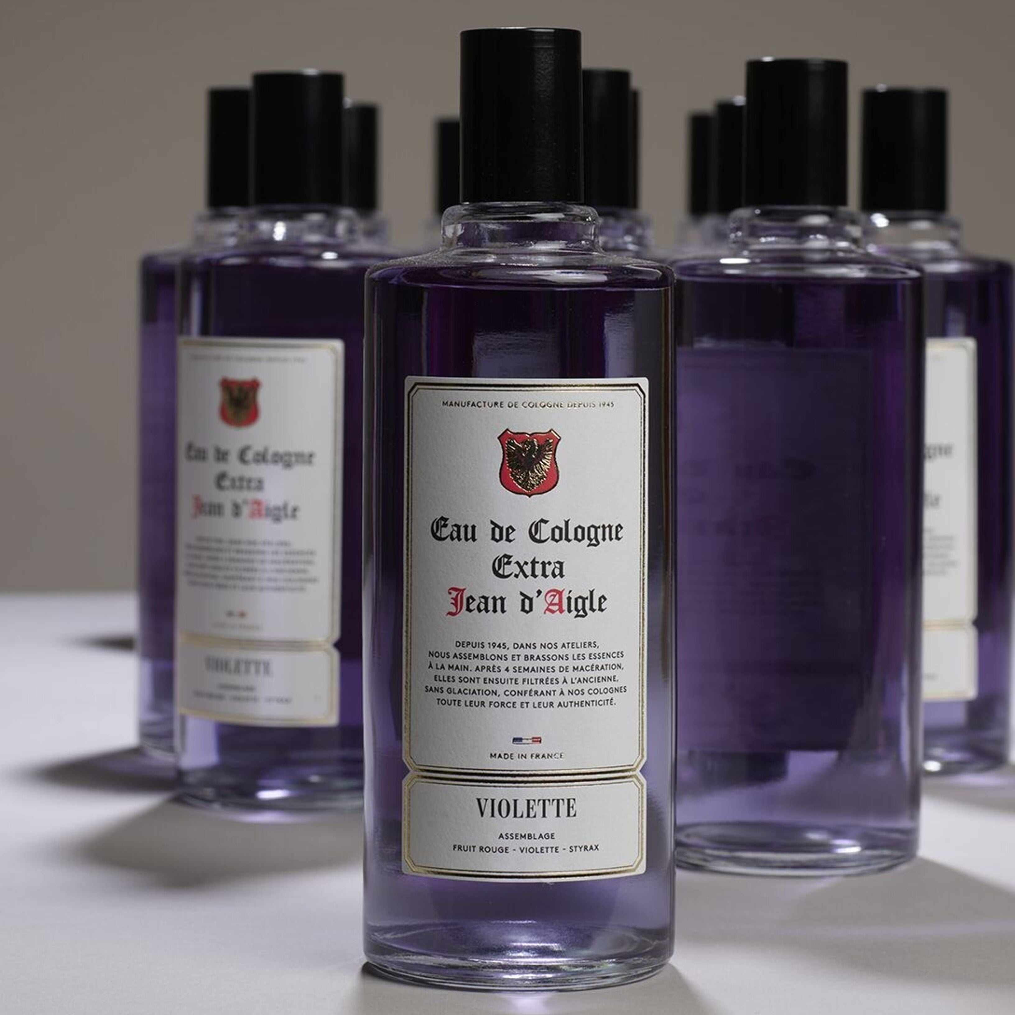 Bottles of Eau de Cologne Extra Jean d'Aigle Violette on a neutral background