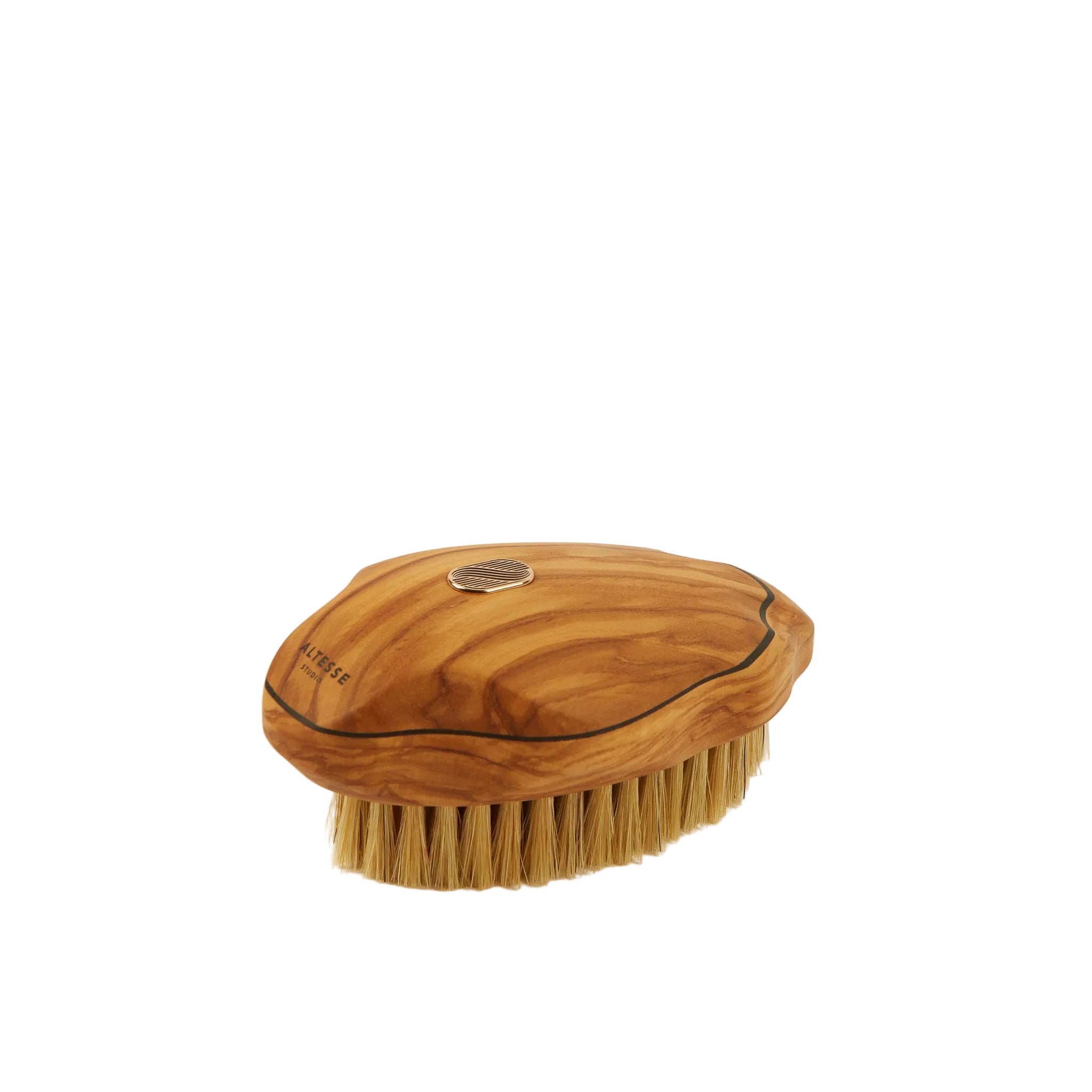 An oval-shaped wooden hair brush with natural olive wood grain, natural bristles, and a small metallic circular emblem on top, set against a plain off-white background.