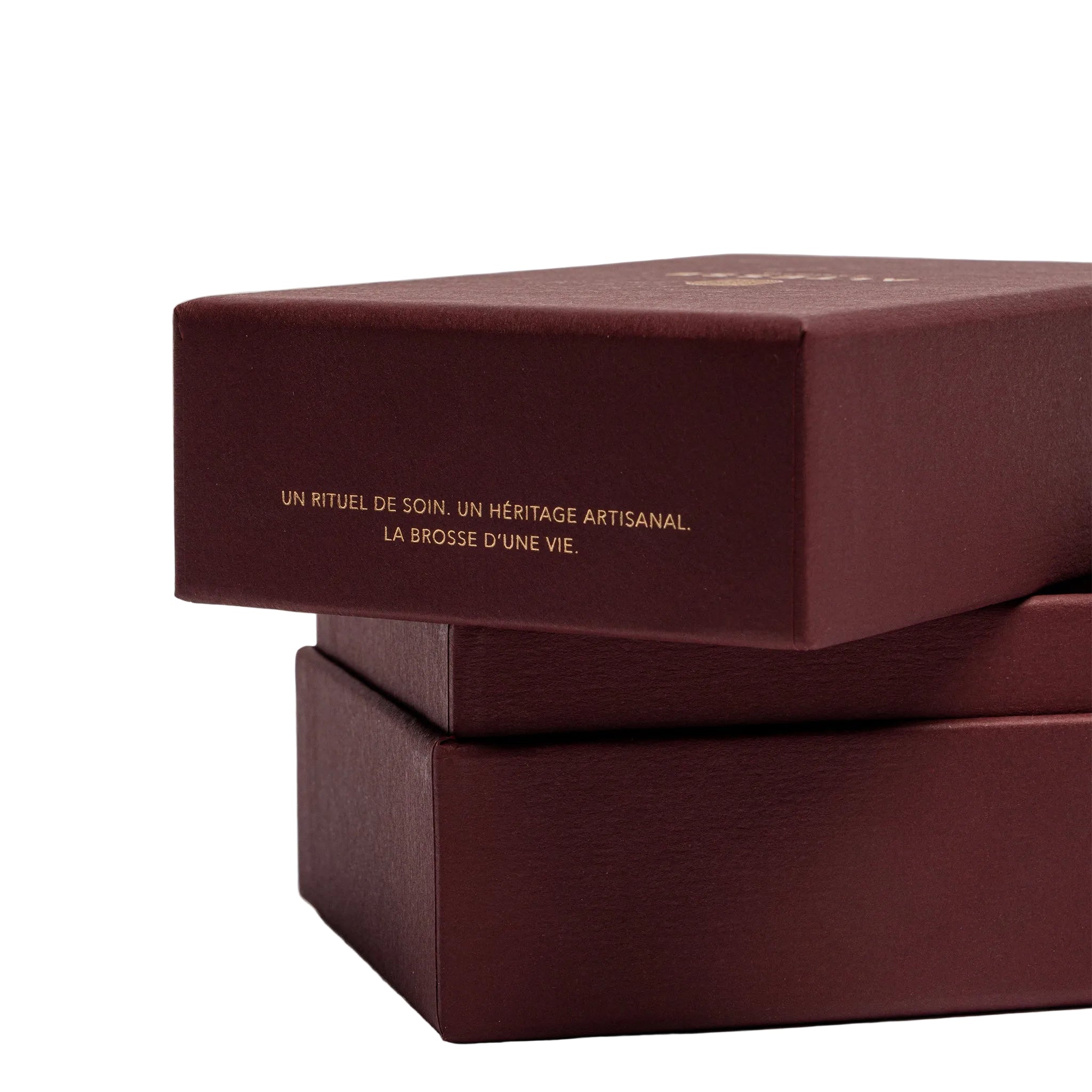 Maroon gift box with gold text on a beige background