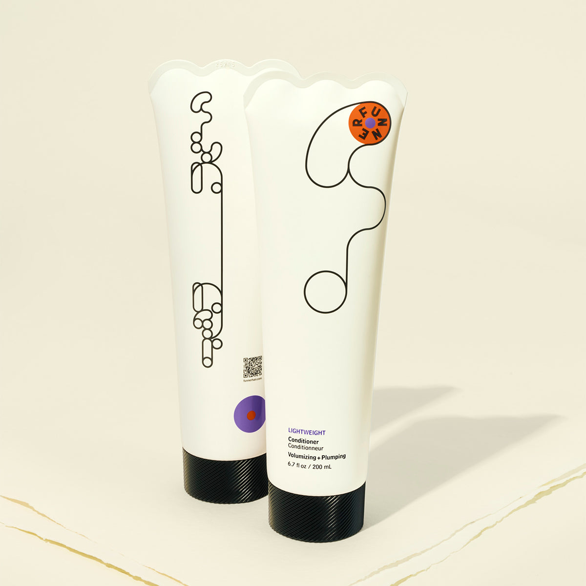 Two white conditioner bottles with black text and design elements on a beige background
