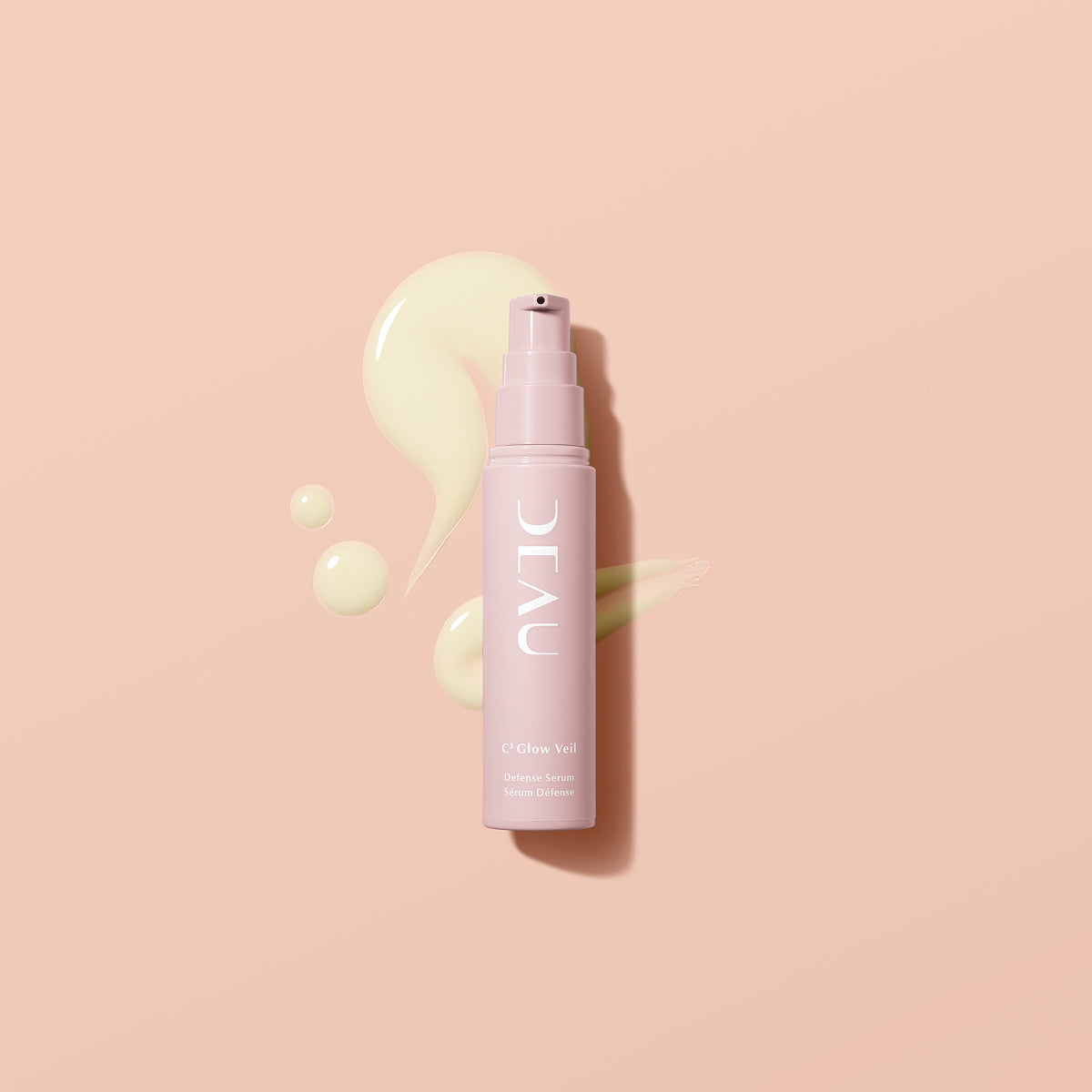 Pink spray bottle with 'Deau' branding on a beige background
