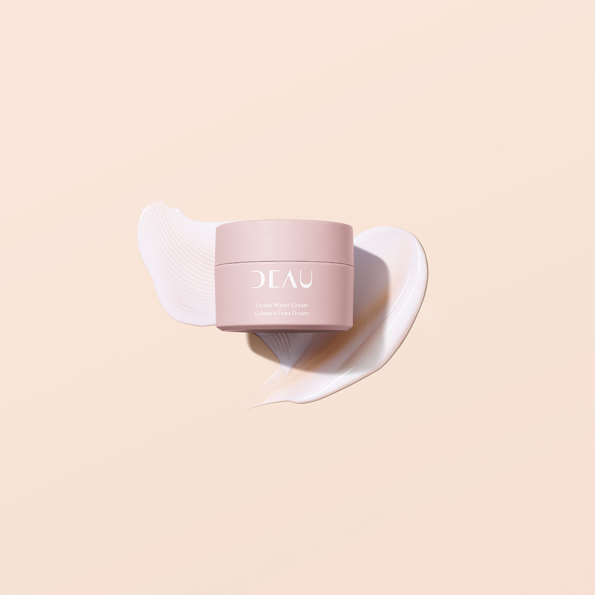 Pink skincare product with brand logo on a beige background