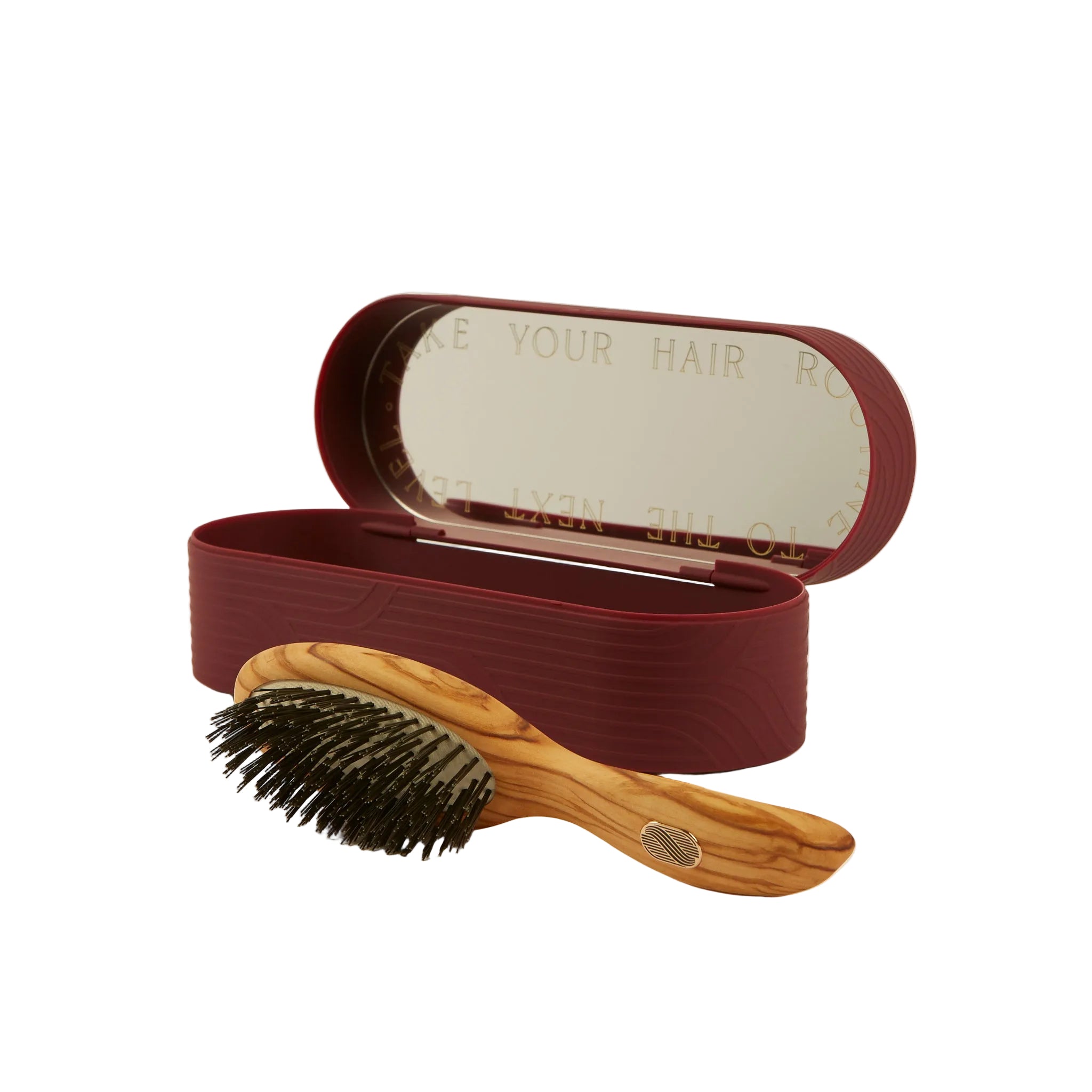 An olive wood hairbrush with black bristles displayed in front of its matching dark burgundy storage case with an open mirror lid, set against a clean off-white background.