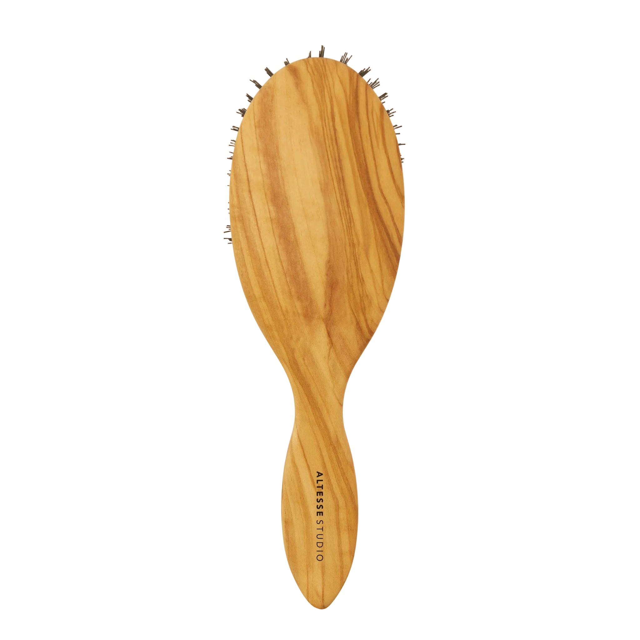 An oval wooden hairbrush with a natural olive wood grain pattern and dark bristles, featuring the brand name printed on the handle, set against a plain off-white background.
