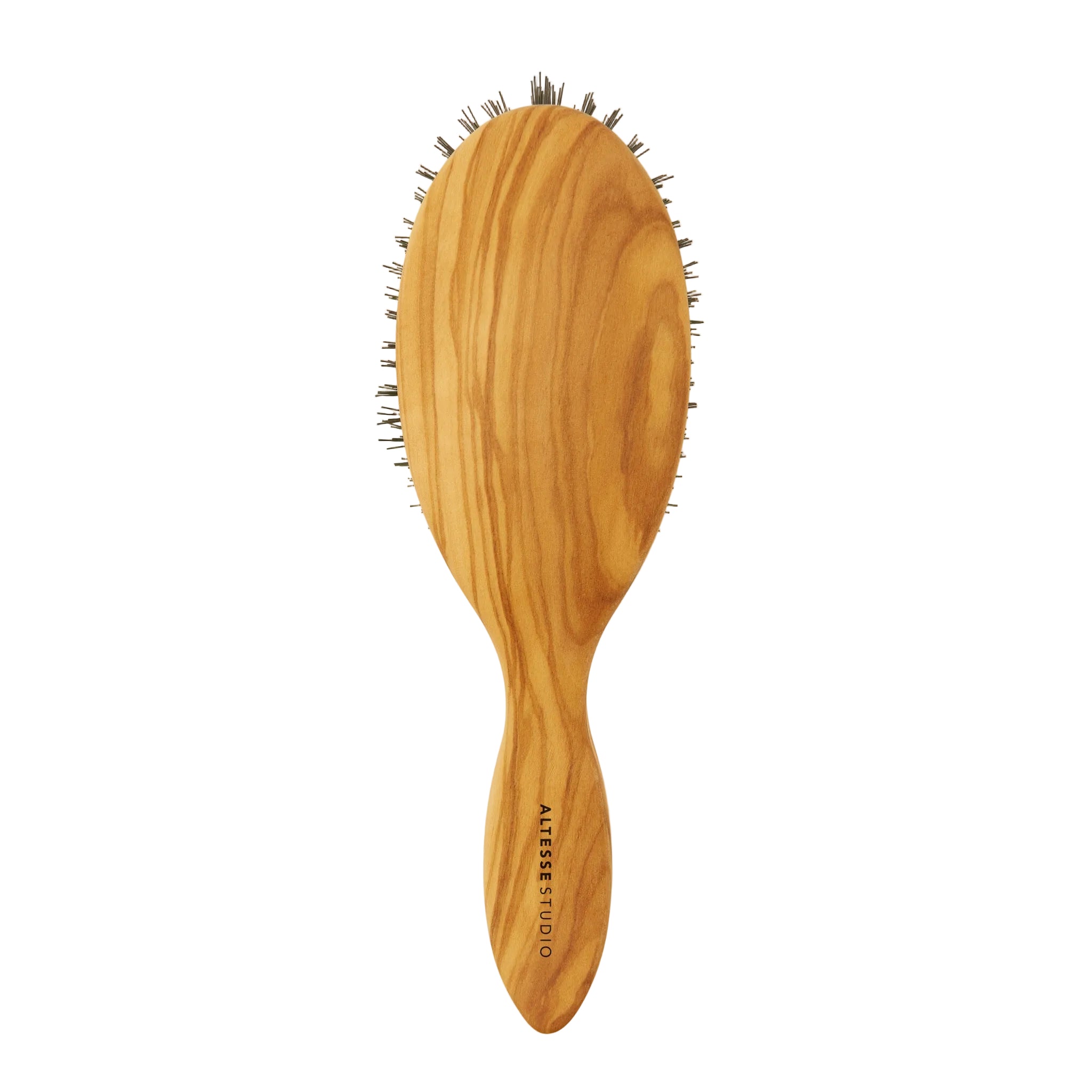 An oval wooden hairbrush with a natural olive wood grain handle and dark bristles, shown against a solid off-white background. The brand name  is printed vertically on the handle.