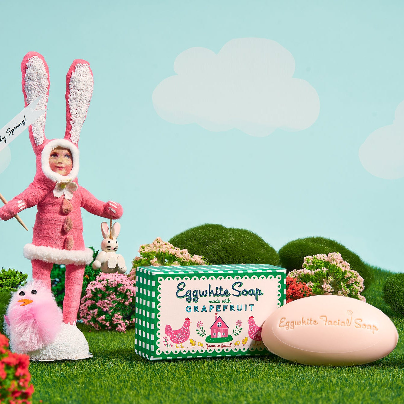 Eggwhite Soap Grapefruit product with a character in a pink bunny costume against a light blue sky with clouds.