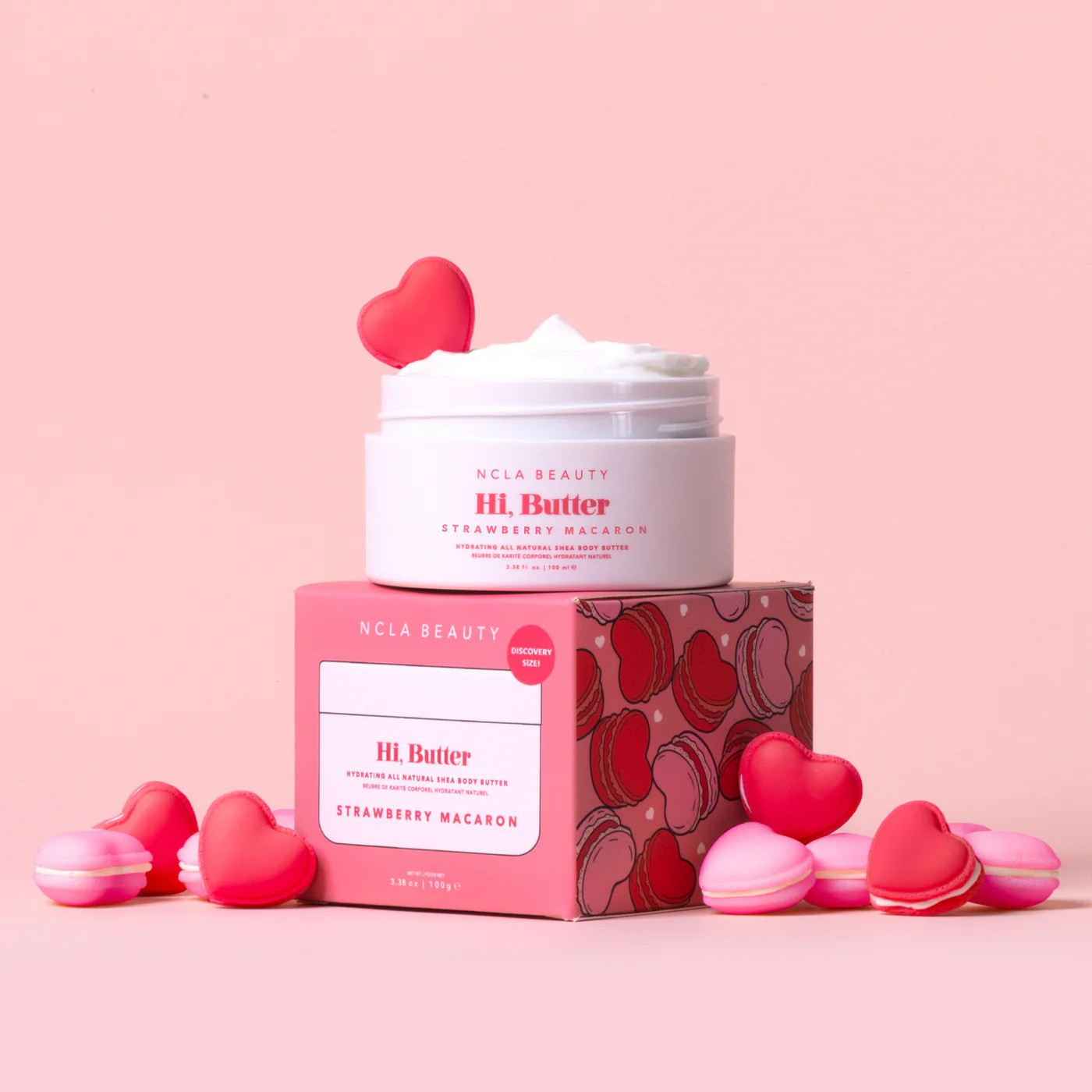 NCLA Beauty HI Butter Strawberry Macaron product with heart-shaped packaging and macarons on a pink background
