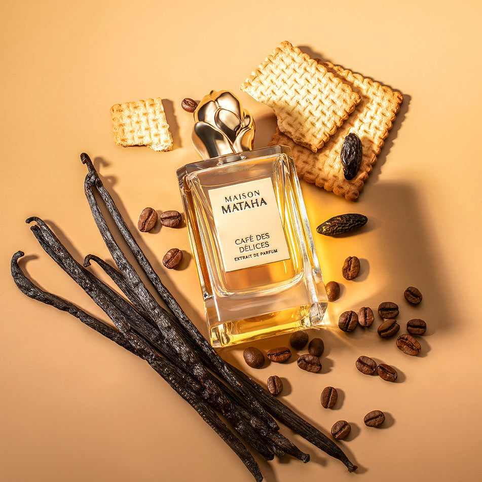 Perfume bottle surrounded by coffee beans and biscuits