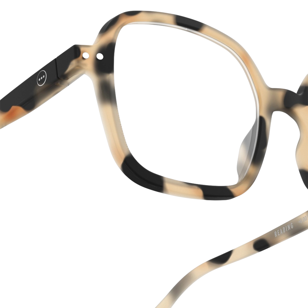 Close-up of tortoiseshell eyeglasses on a white background