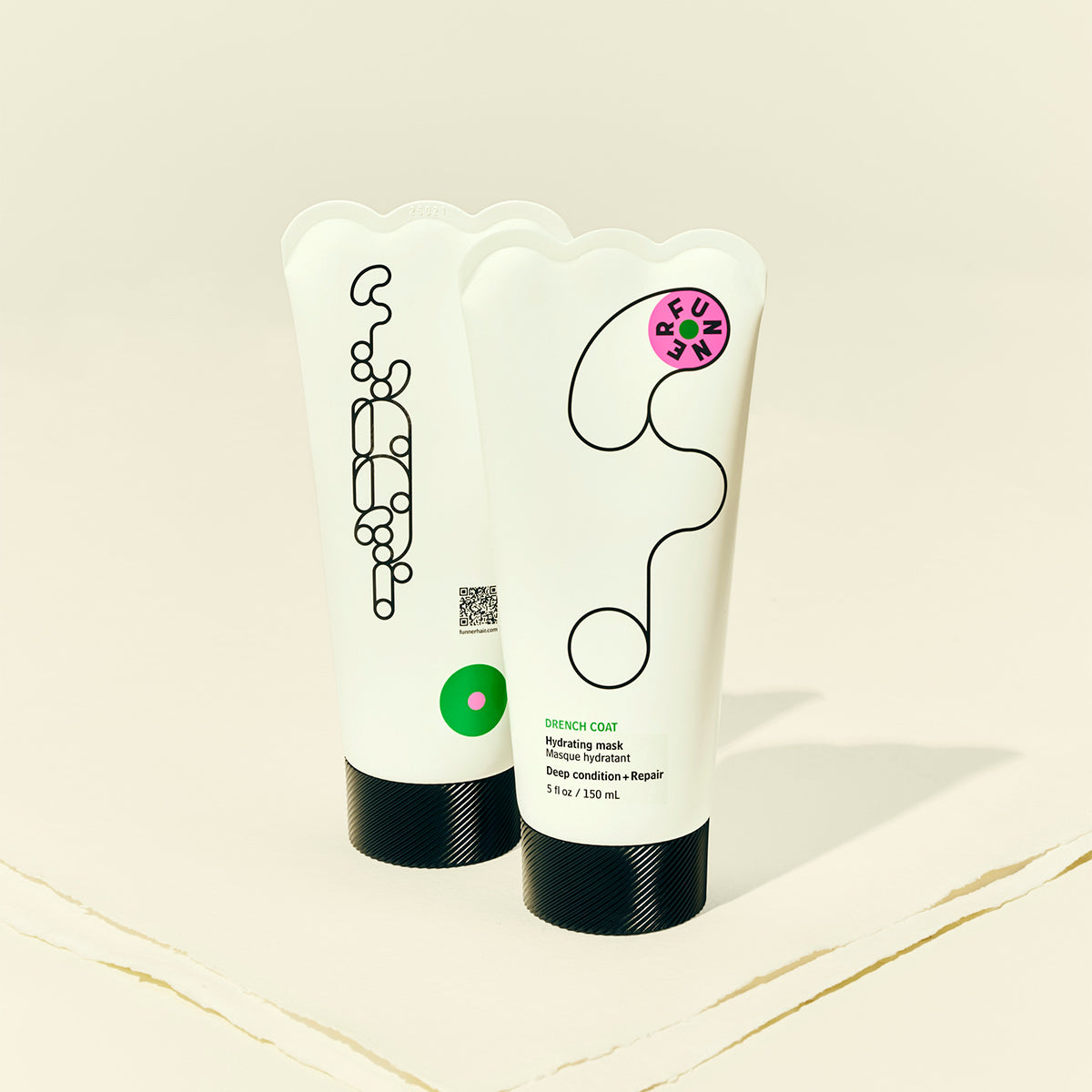 Two haircare products with unique designs on a light beige background