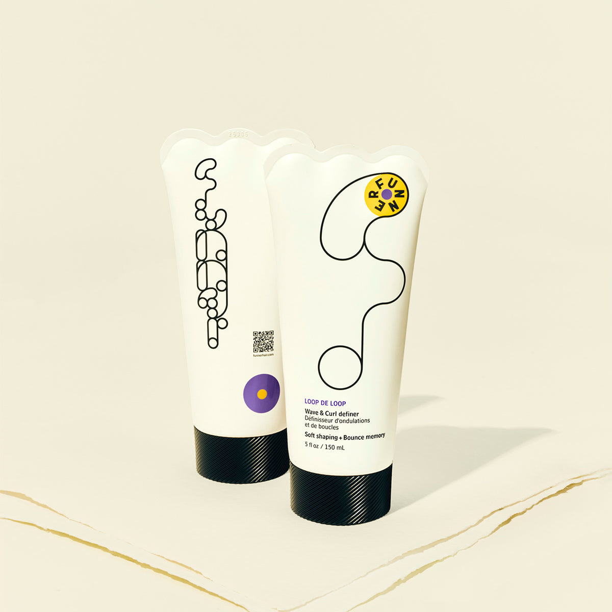 Two hair care products with branding on a beige background