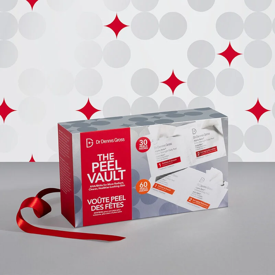 Box of 'The Peel Vault' with a red ribbon on a gray surface and patterned background