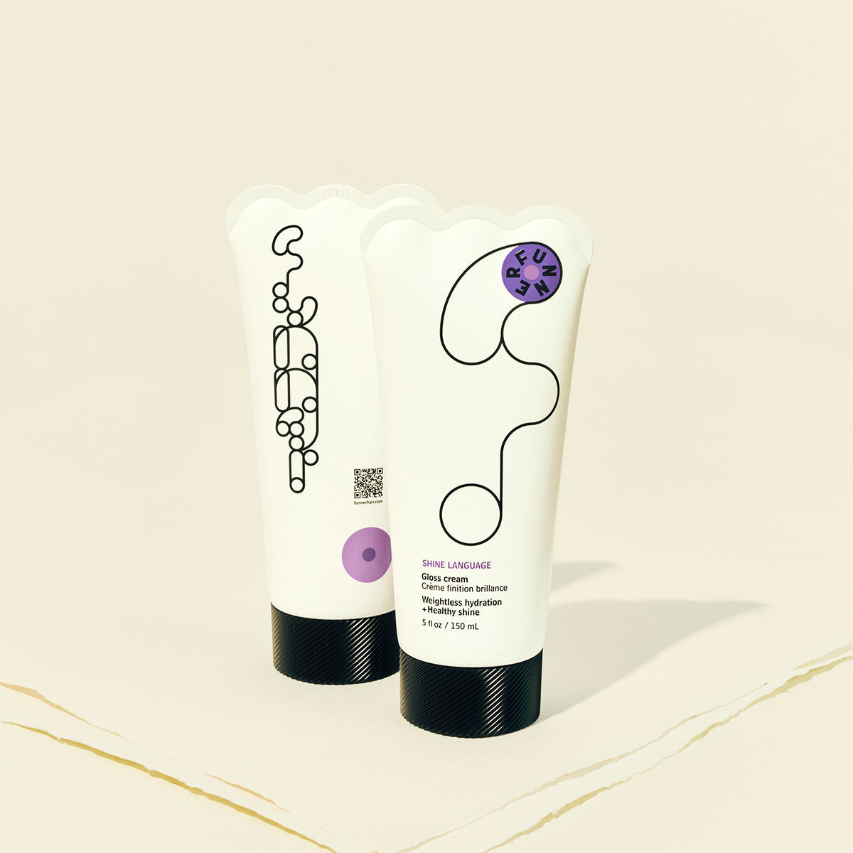 Two tubes of cream with black and white packaging on a beige background